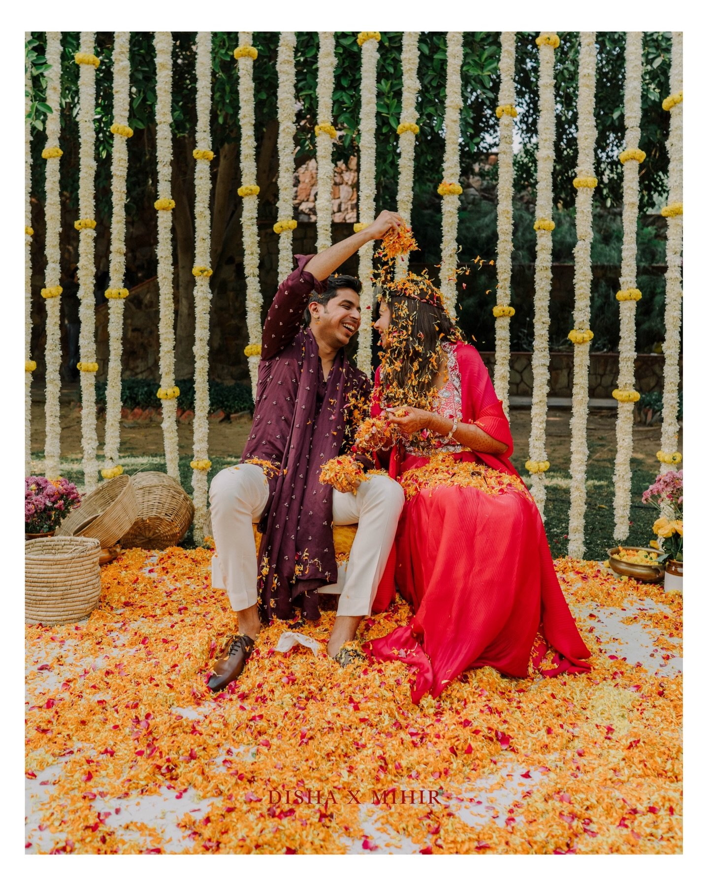 A couple playing together amid a shower of flower petals